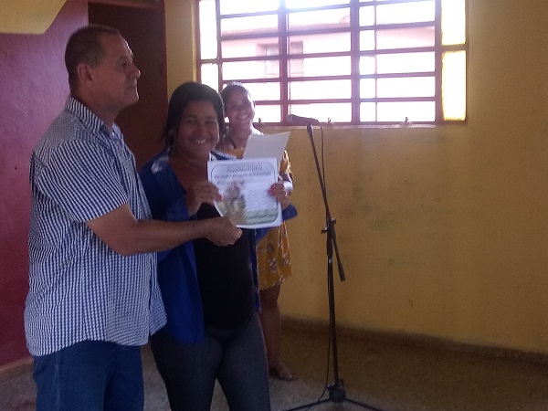 Arletys Rivera, presidenta de la Cooperativa de Créditos y Servicios Jesús Menéndez, recibe un reconocimiento por los resultados durante el pasado año. 